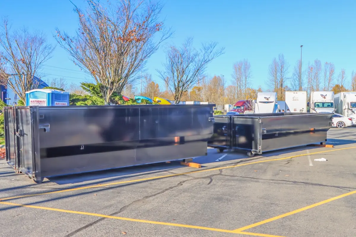 Professional dumpster rental service with roll-off container on residential driveway in Olivarez